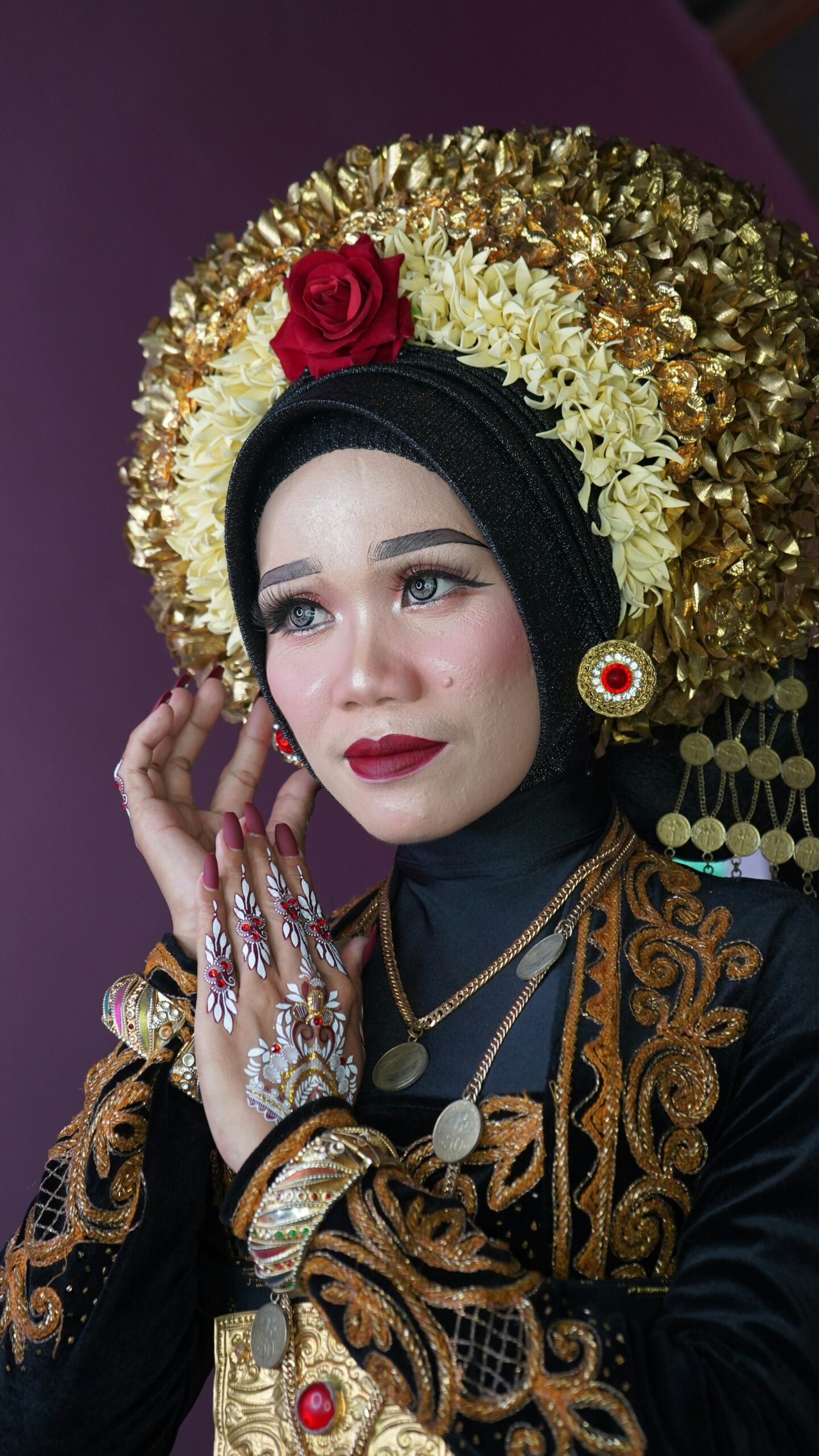 A woman wearing a headdress with a flower in her hair